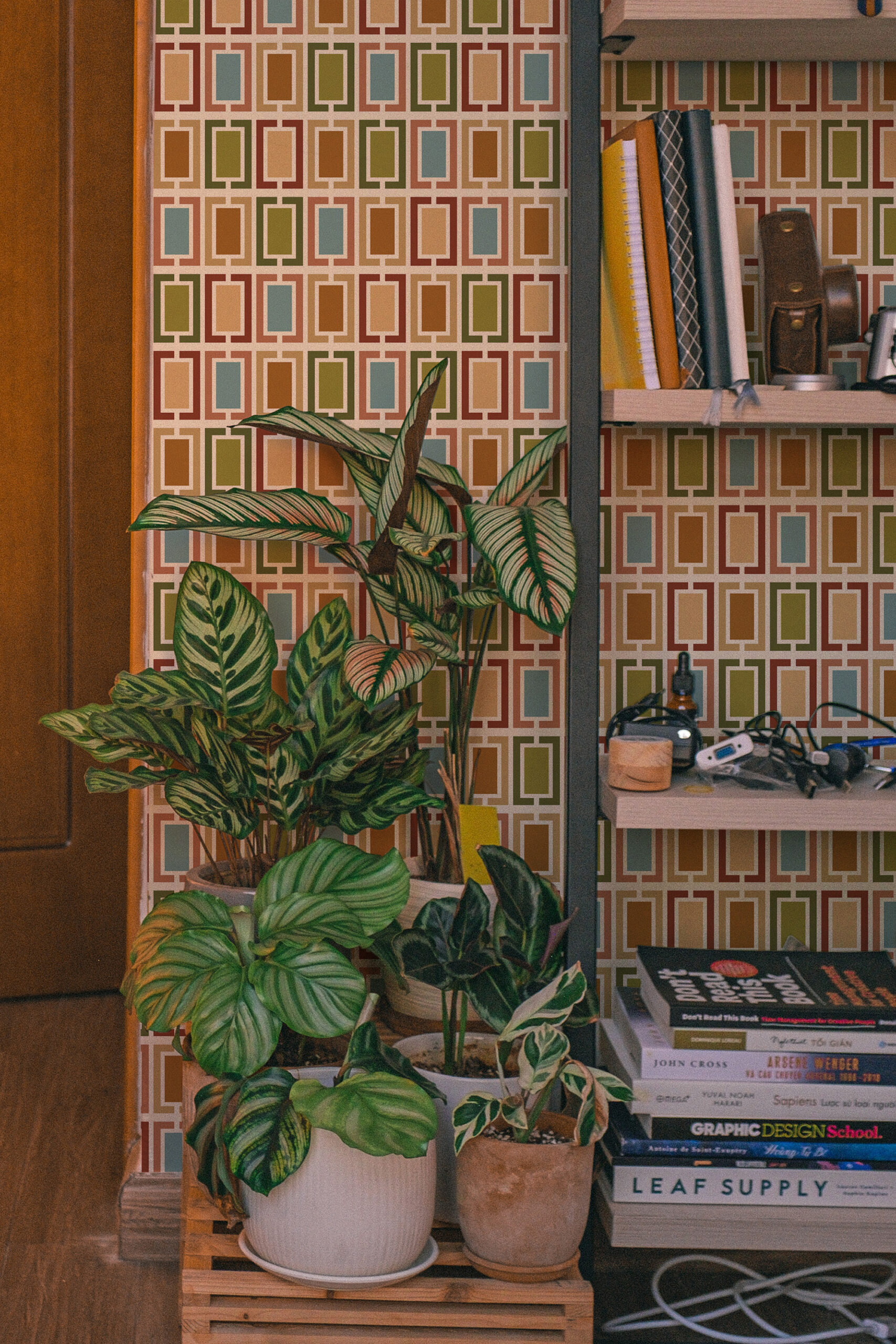 Retro White Geometric Frames non-pasted wallpaper with multicolor rectangular frames behind a shelving unit.