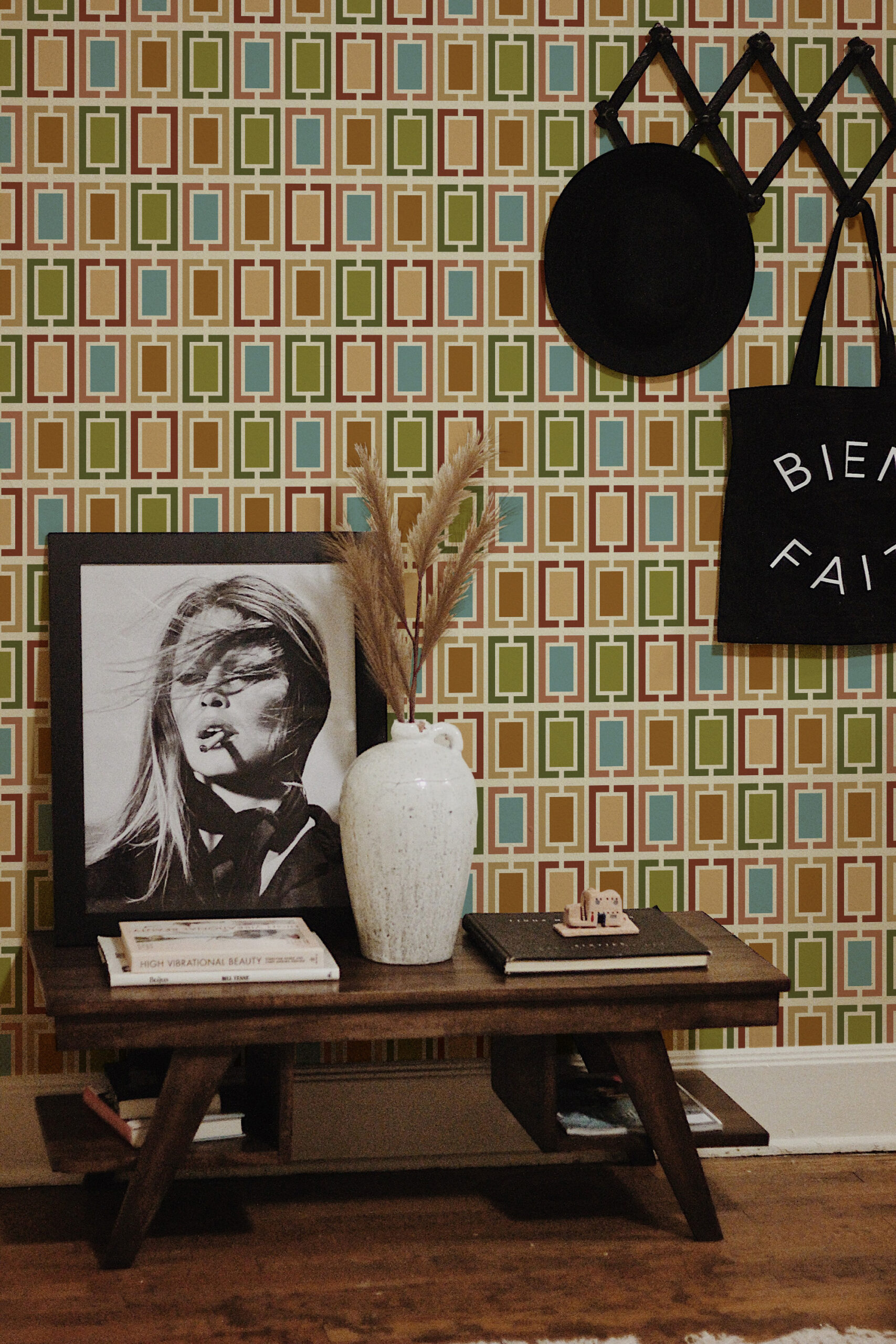 Retro White Geometric Frames pre-pasted wallpaper with a grid of multicolor rectangular frames behind a small console table.