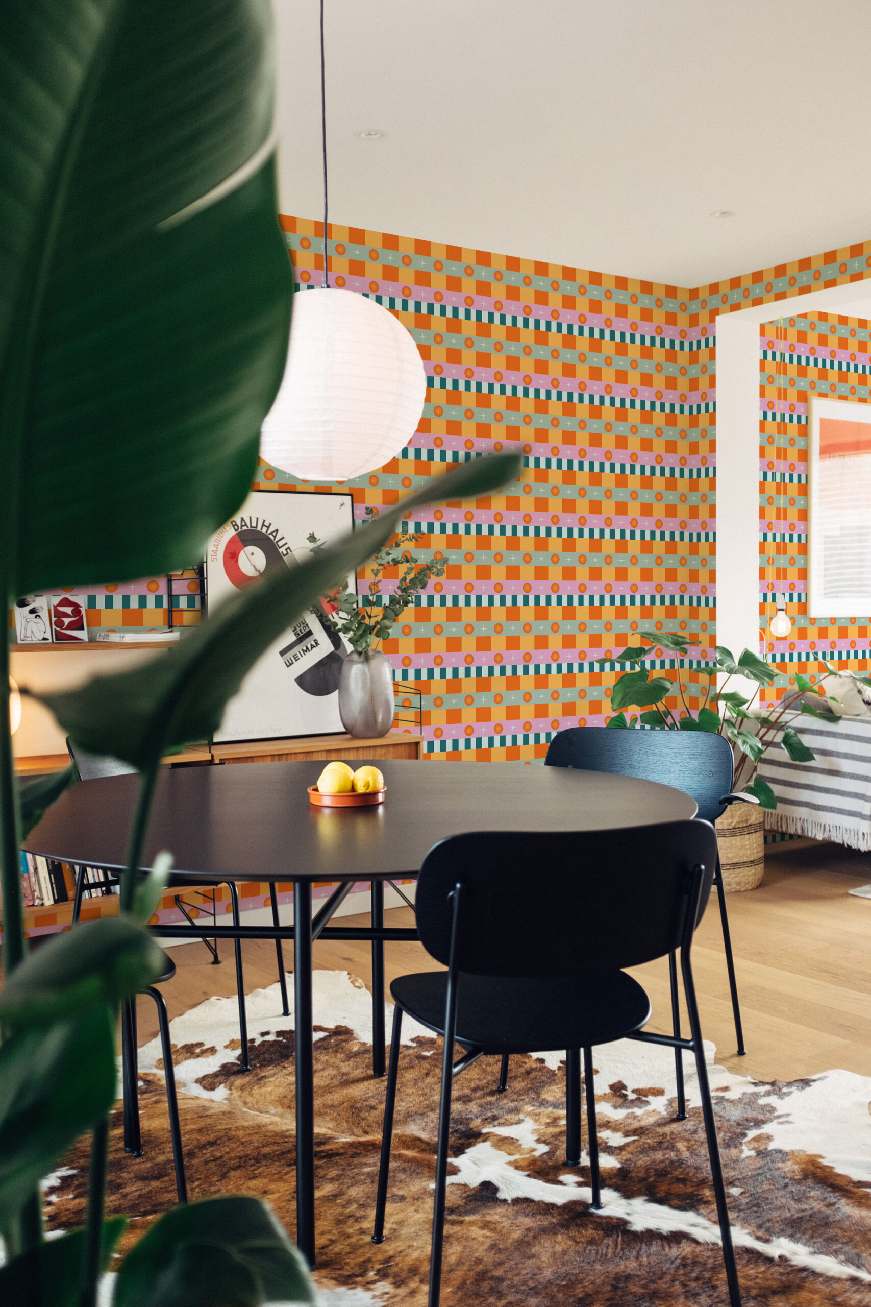 Retro Orange Stripe traditional wallpaper in a dining area, with multicolor striped bands and orange checker blocks.