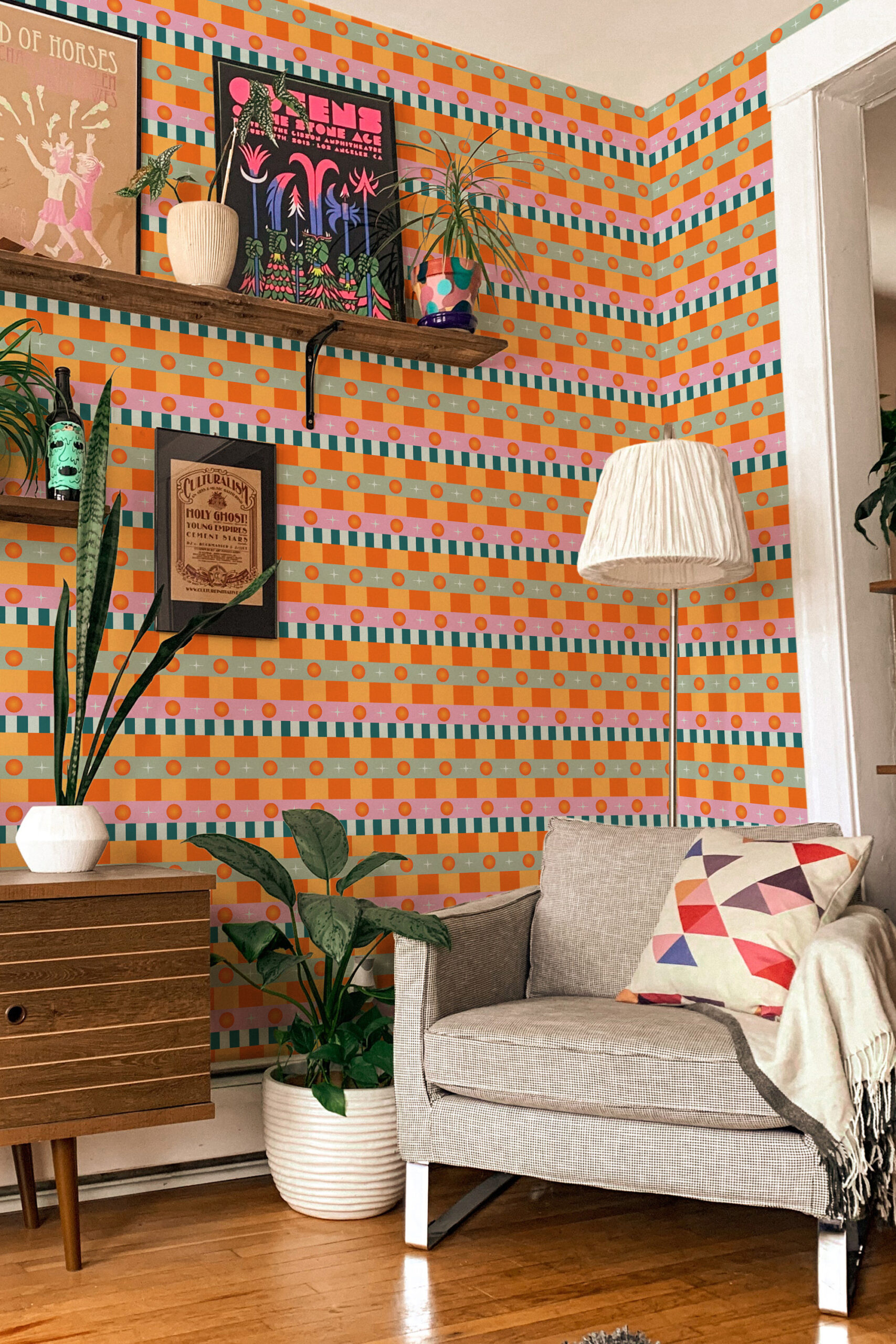 Retro Orange Stripe peel and stick wallpaper with horizontal orange check bands and teal stripes wrapping a living room corner.