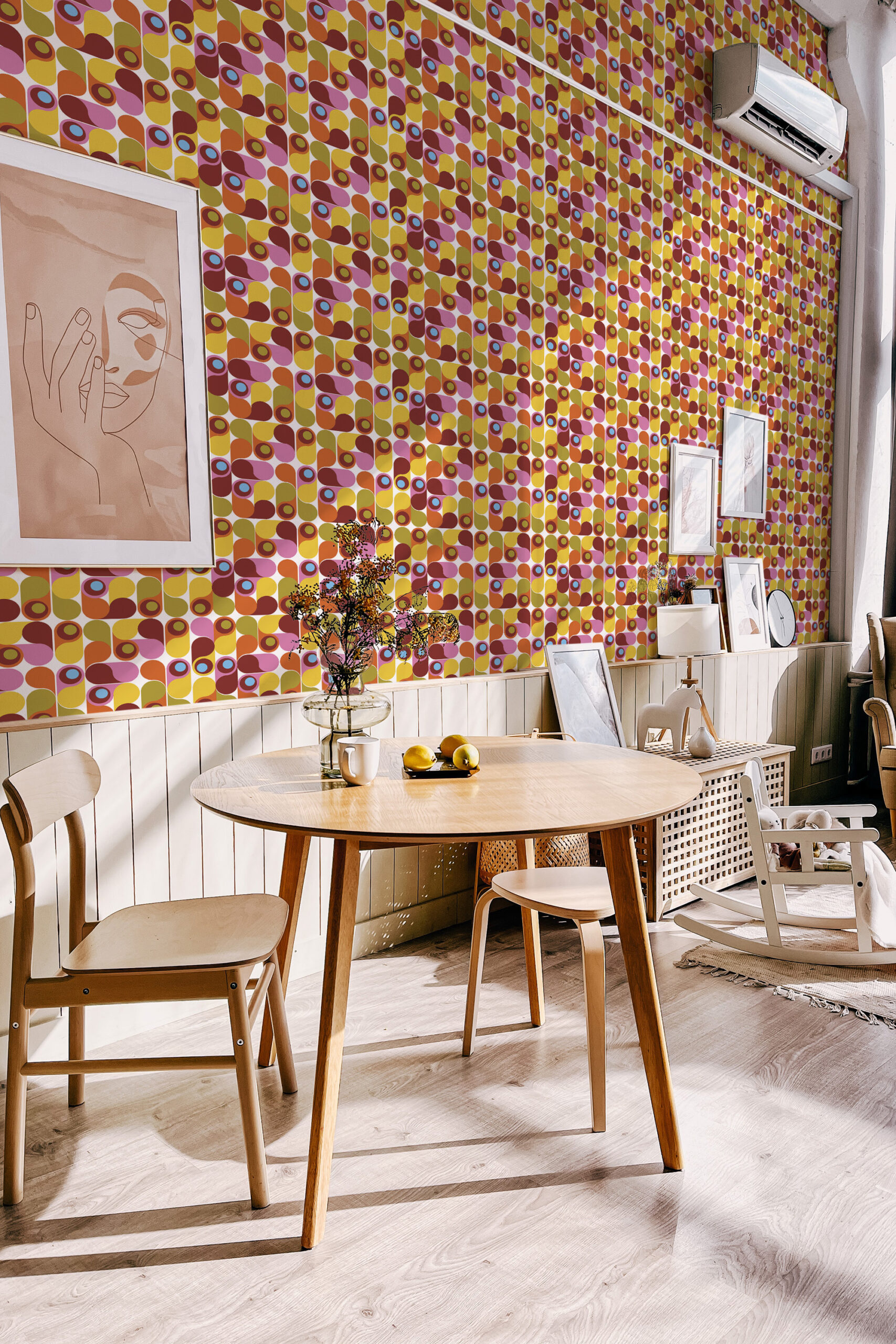 Colorful Retro Teardrop Shapes non-pasted wallpaper covering a dining room wall featuring repeating oval and circle blocks in pink, orange, and olive.