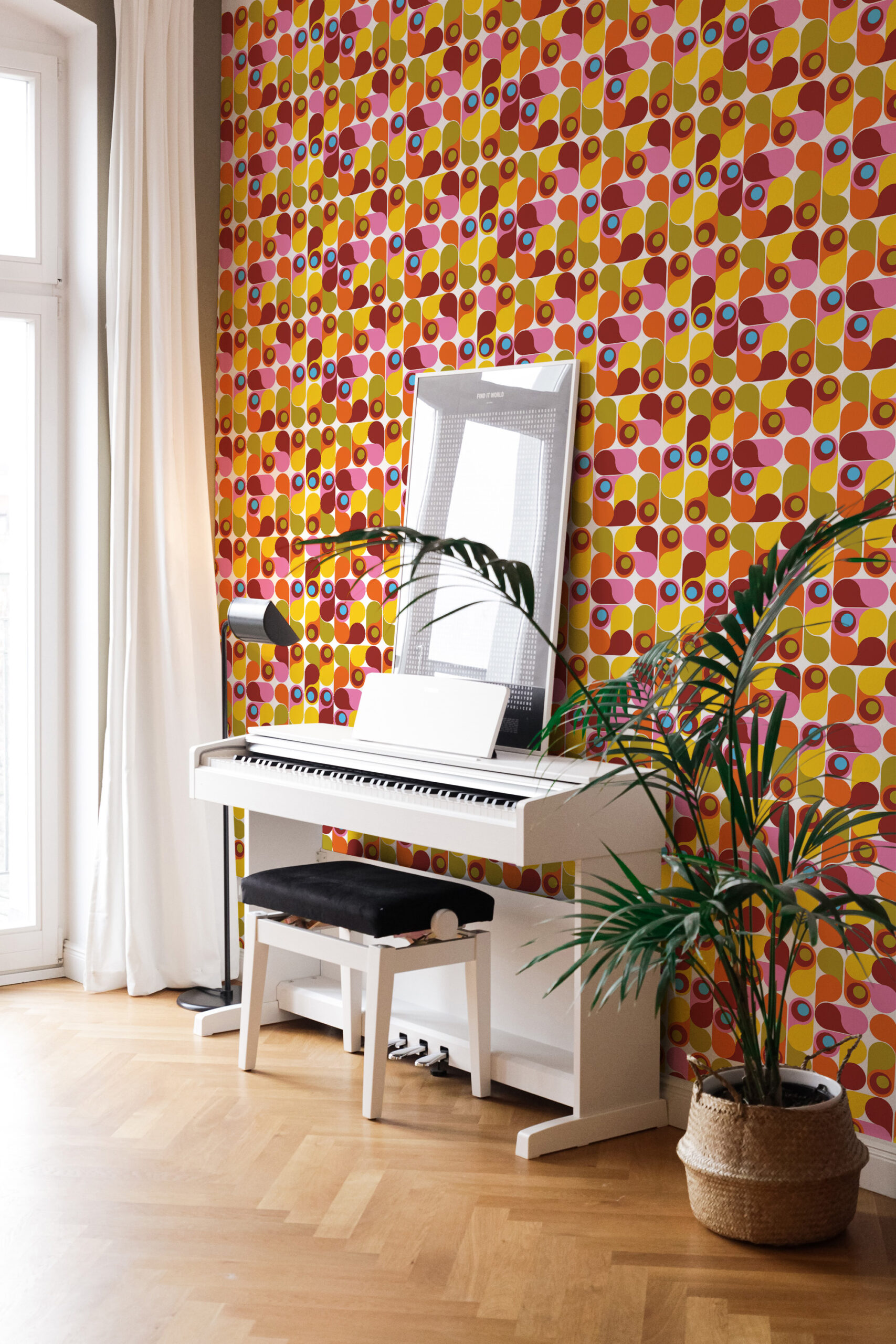 Colorful Retro Teardrop Shapes pre-pasted wallpaper covering an accent wall behind a white piano with layered geometric dots.