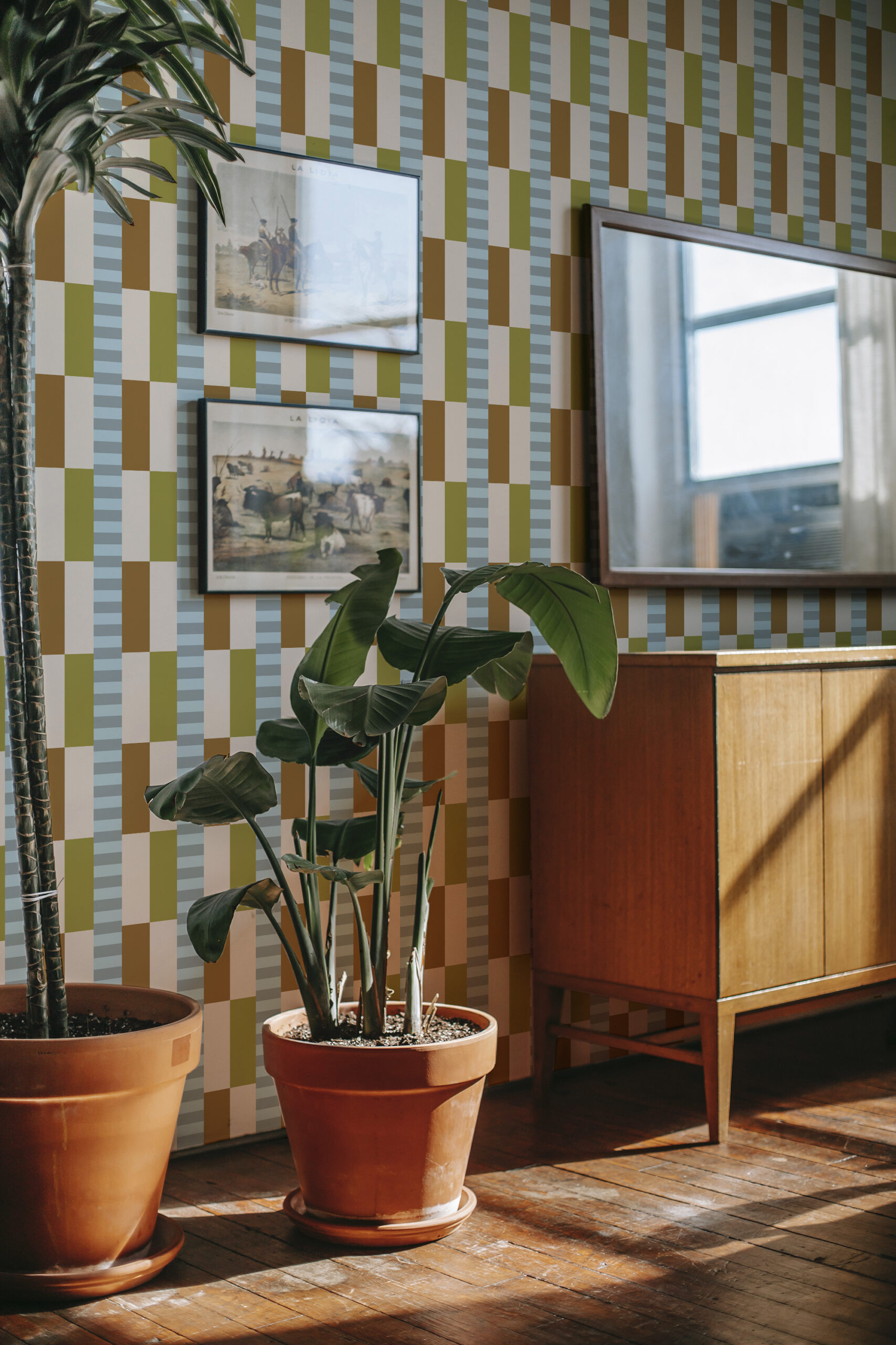 Retro Beige Geometric peel and stick wallpaper with a blocky check pattern in beige, olive, and blue behind framed art.