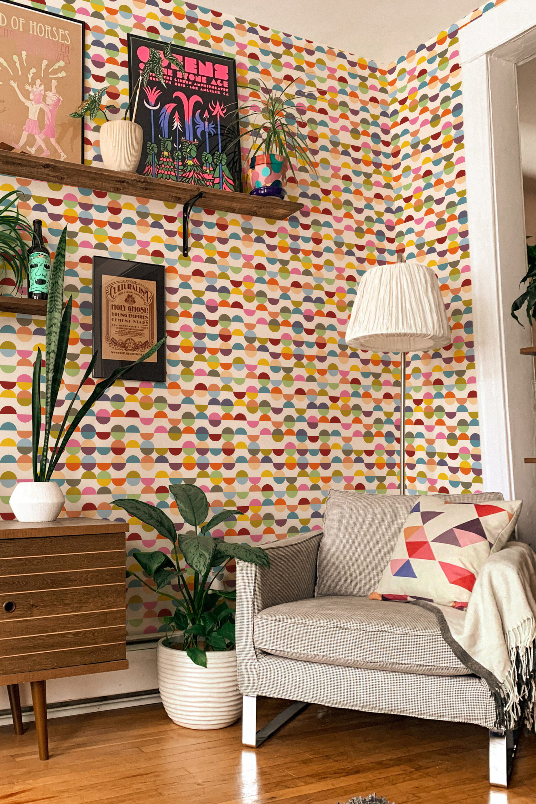 Colorful Retro Half-Circle non-pasted wallpaper with multicolor half-moon rows covering an accent wall behind a sofa.