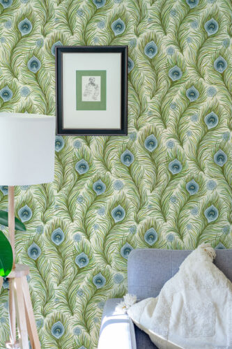 Boho Green Peacock Feather peel and stick wallpaper with green fronds and blue eye feathers behind a framed print.