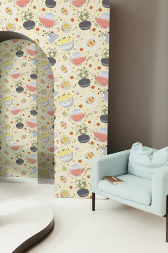 Whimsical Cream Dinnerware peel and stick wallpaper with teapots, plates, bowls, and tiny tomatoes across an accent wall.
