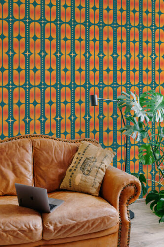 Orange Teal Retro Geometric pre-pasted wallpaper with rounded orange shapes on teal, shown behind a leather sofa.