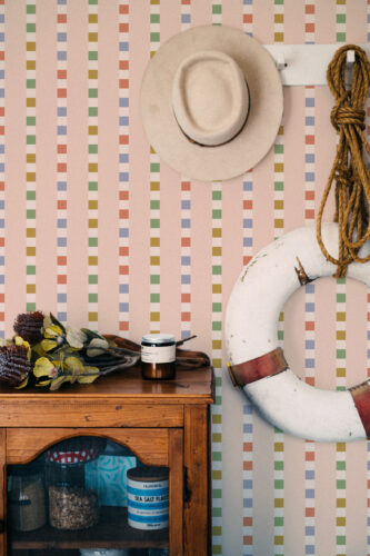 Retro Pink Striped Geometric peel and stick wallpaper with vertical pastel stripes and small multicolor blocks on a full wall.
