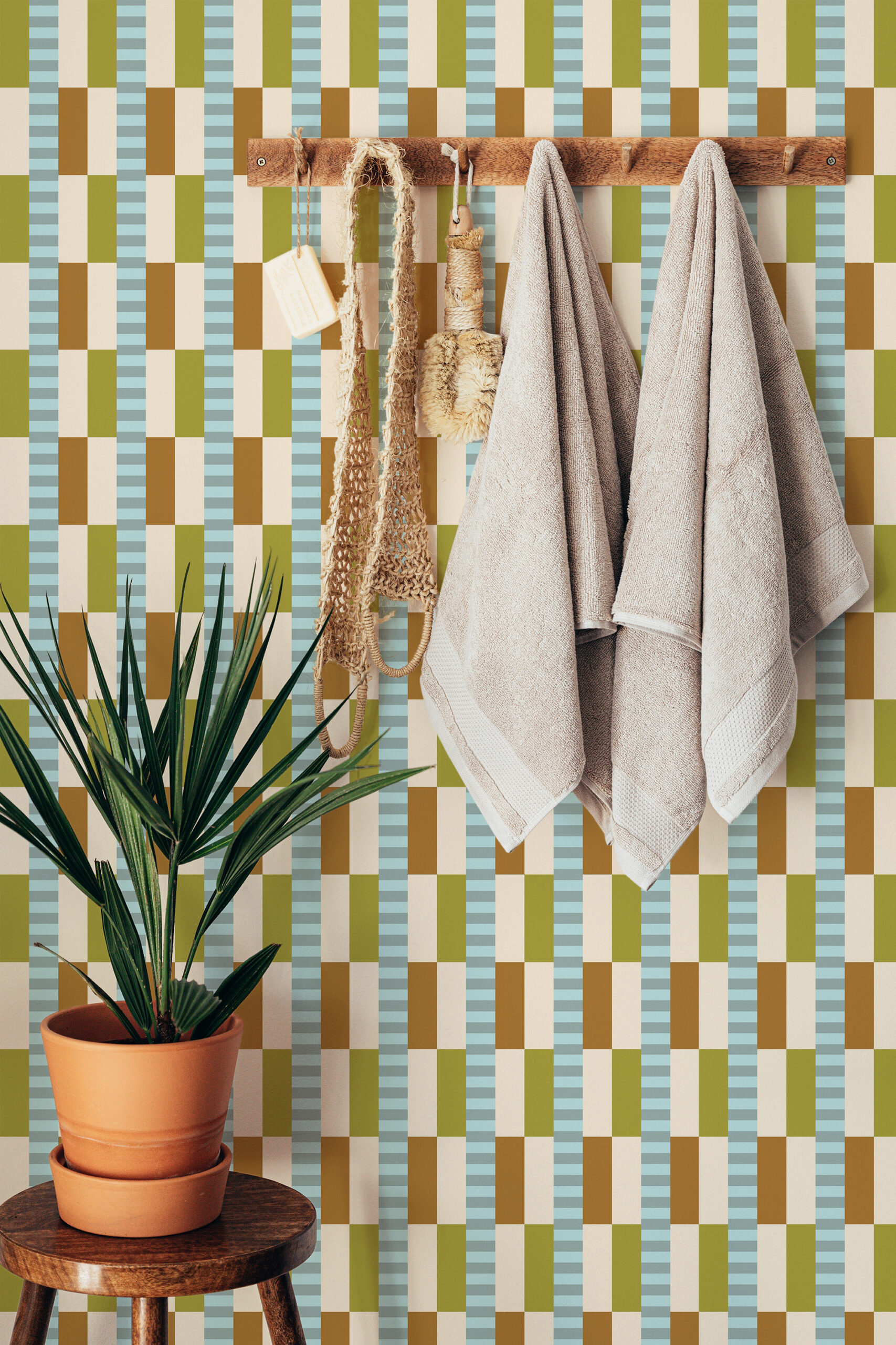 Retro Beige Geometric pre-pasted wallpaper with a checkered stripe pattern behind a wooden hook rail and towels.