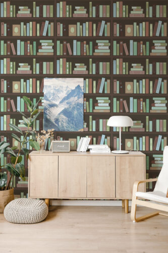 Vintage Brown Bookshelf peel and stick wallpaper with illustrated rows of colorful books across the wall behind a wood sideboard.