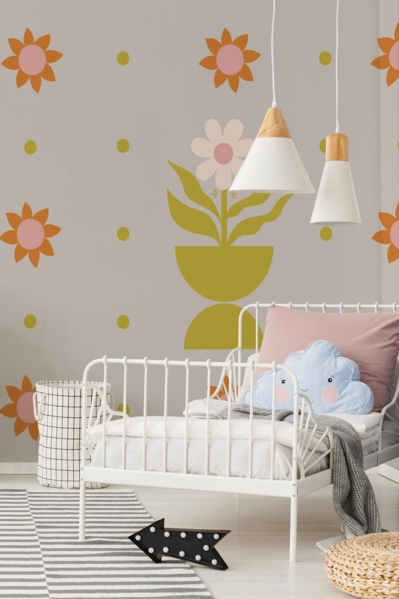 Playful Floral Pots pre-pasted wall mural with a large potted flower and orange blooms behind a white child’s bed in a nursery.