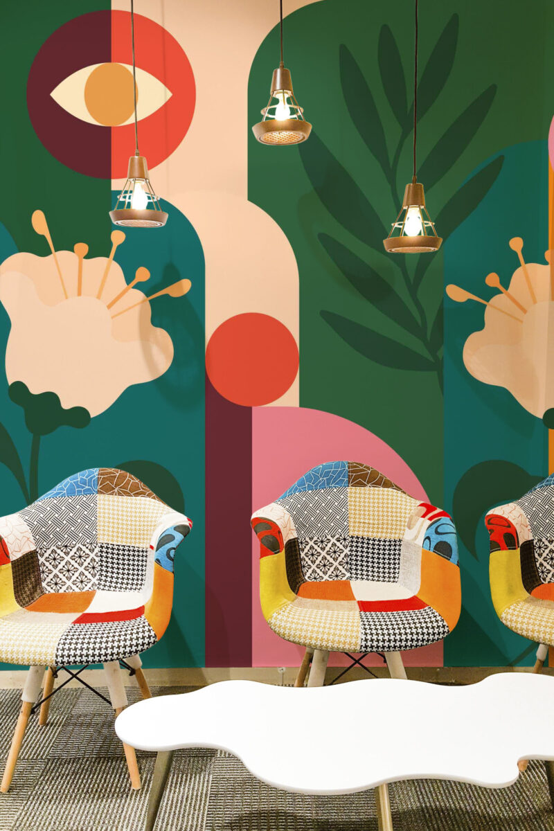 Retro Floral Garden peel and stick wall mural spans an accent wall featuring bold geometric blooms and leafy shapes in green, coral, and cream.
