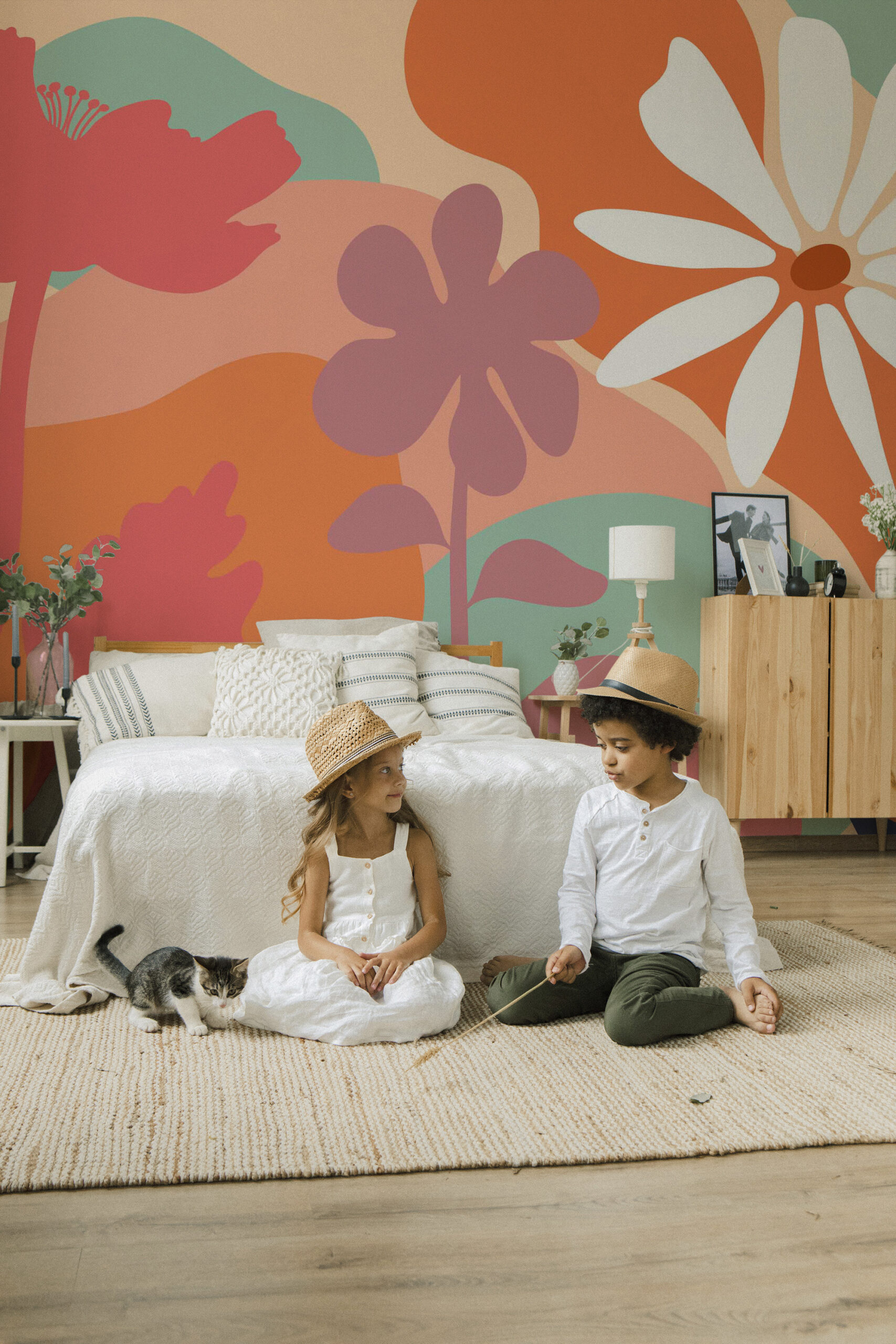 Peach Boho Floral covers a bedroom wall mural with oversized abstract flowers in peach, coral, teal, and white behind the bed.
