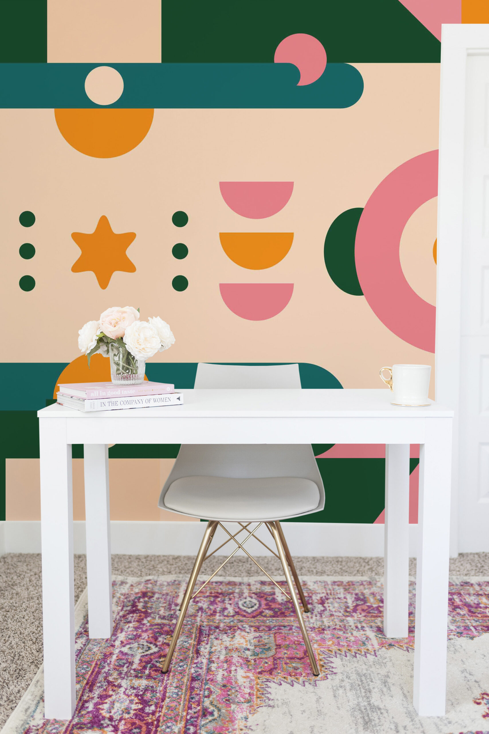 Retro Geometric Star non-pasted wall mural with bold green, pink, and orange shapes covering the full wall behind a small white desk.