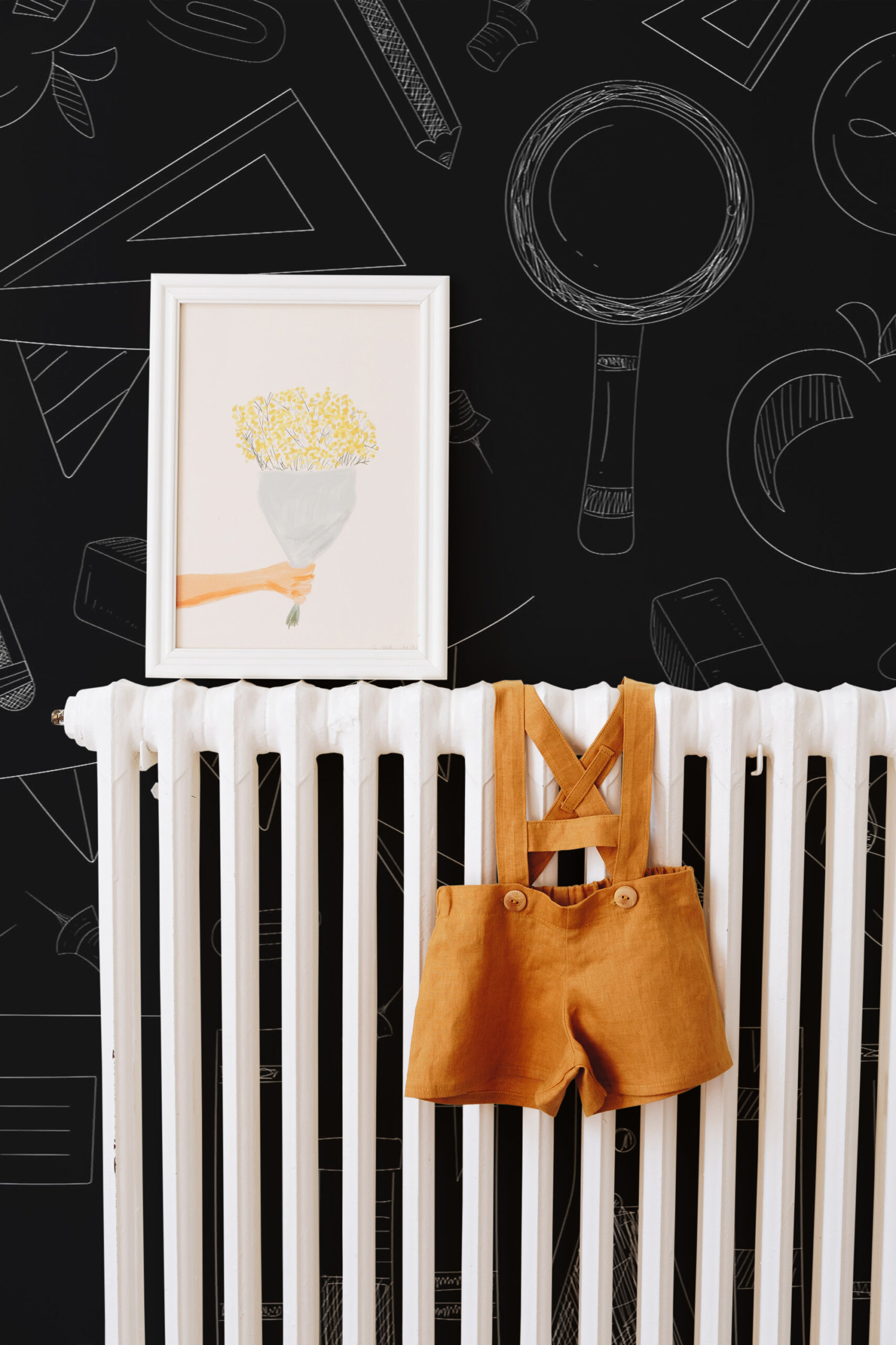 Chalkboard School Doodles self-adhesive wall mural with chalk-style classroom icons on a black background behind a white radiator.
