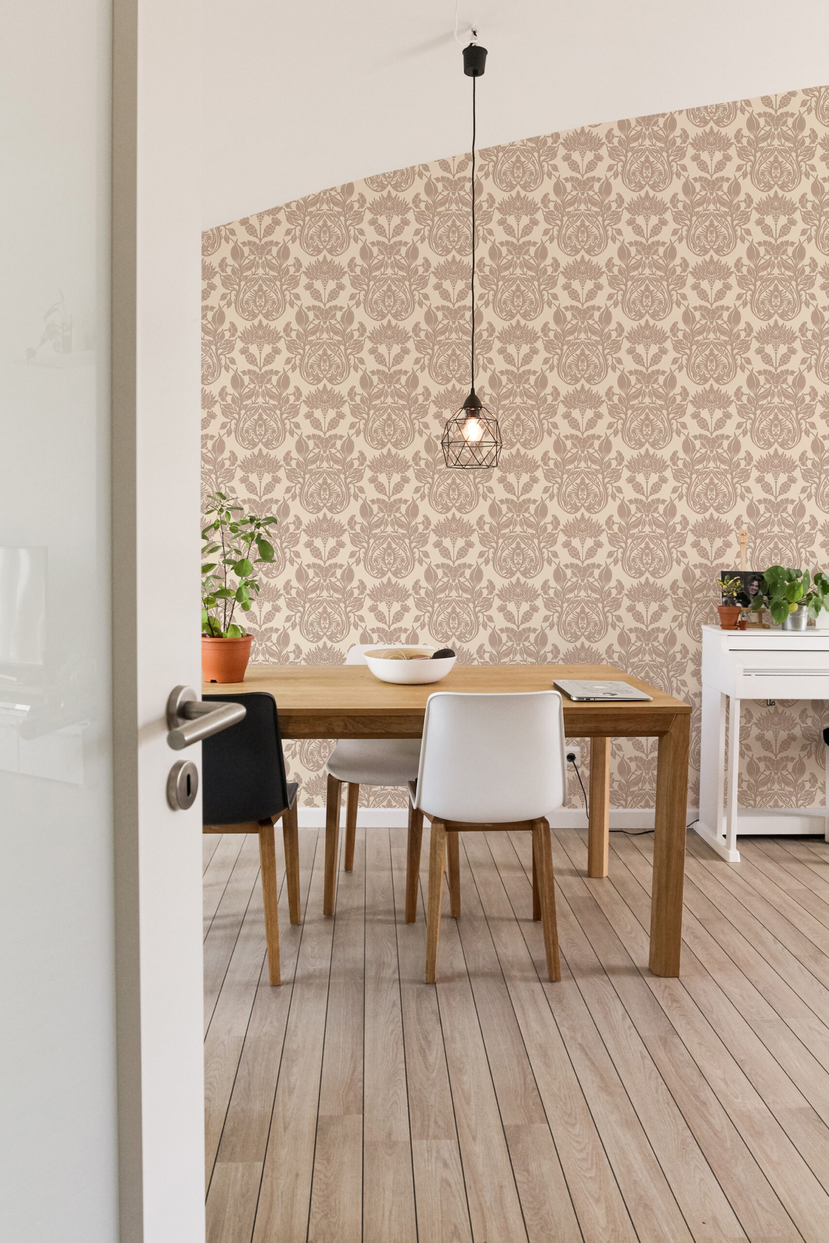 Vintage Cream Damask self-adhesive wallpaper covering a dining room accent wall with an ornate floral medallion pattern.