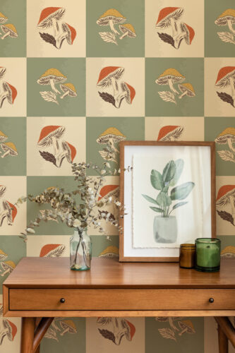 Whimsical Beige Sage Mushroom peel and stick wallpaper with alternating sage and beige squares and illustrated orange mushrooms.