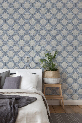 Vintage Blue Leaf Damask peel and stick wallpaper on a bedroom accent wall behind the bed, with repeating leaf medallions.