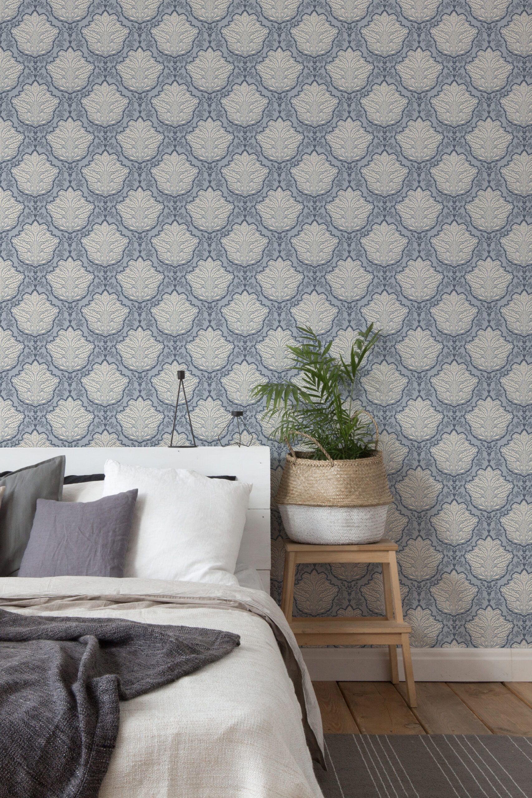 Vintage Blue Leaf Damask peel and stick wallpaper on a bedroom accent wall behind the bed, with repeating leaf medallions.