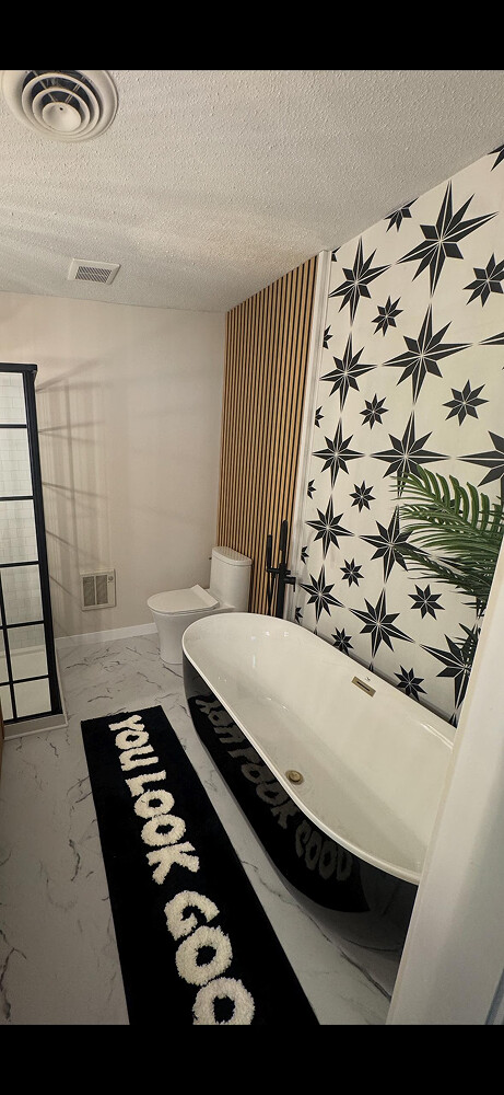 Black and white geometric star peel and stick wallpaper installed in bathroom - review picture submitted by Jurgis