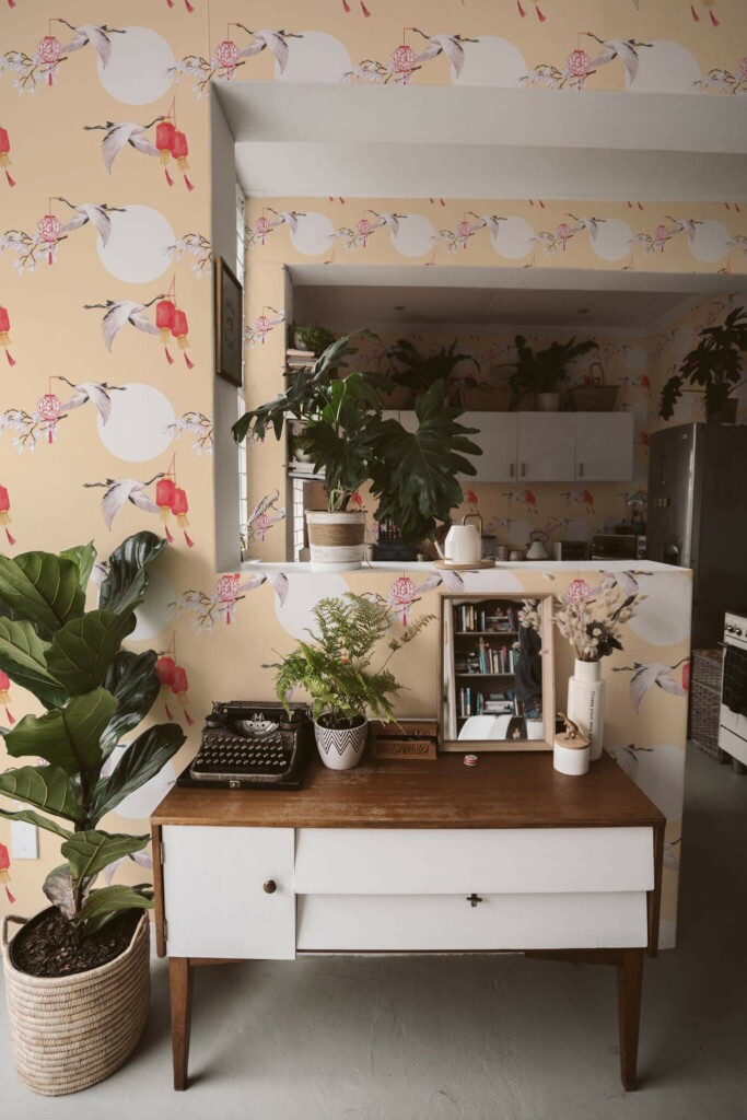 Boho style living room and kitchen decorated with Bird chinoiserie peel and stick wallpaper and green plants