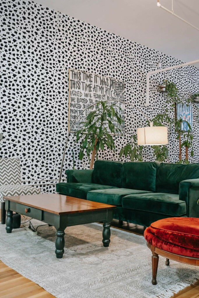 Bold eclectic style living room decorated with Black hand drawn spots peel and stick wallpaper and emerald green sofa