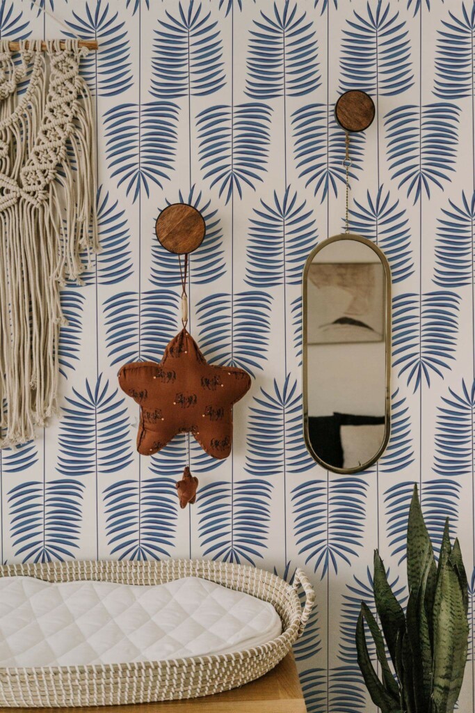 Boho style neutral nursery decorated with Blue and white leaf peel and stick wallpaper