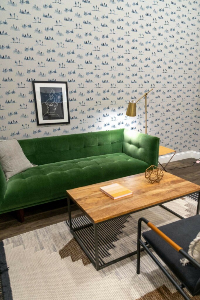 Mid-century modern living room decorated with Blue watercolor forest peel and stick wallpaper and forest green sofa