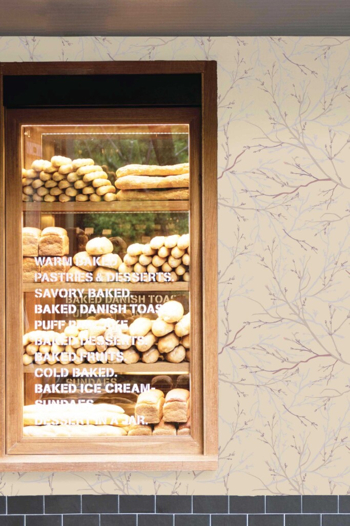 Commercial bakery space with a wall covered in brown tree-branch wallpaper, creating a cozy, nature-connected ambiance. The botanical pattern adds depth and visual interest behind bread display shelves, making it perfect for artisan cafés, spa shops, or eco-conscious retail interiors.