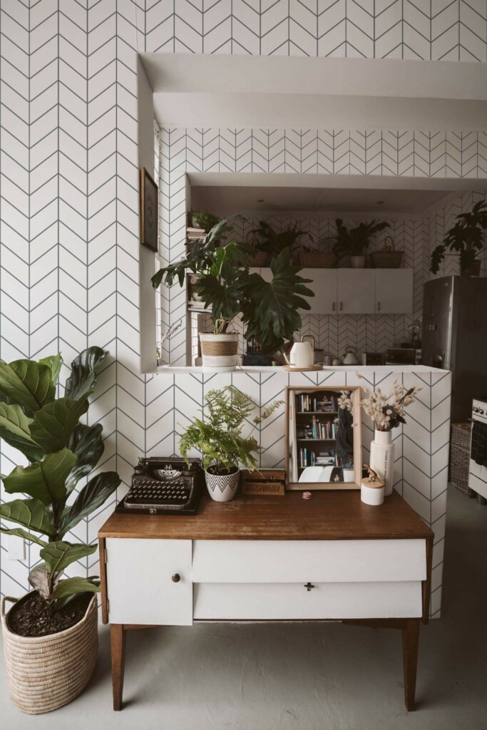 Boho style living room and kitchen decorated with Chevron tile peel and stick wallpaper and green plants