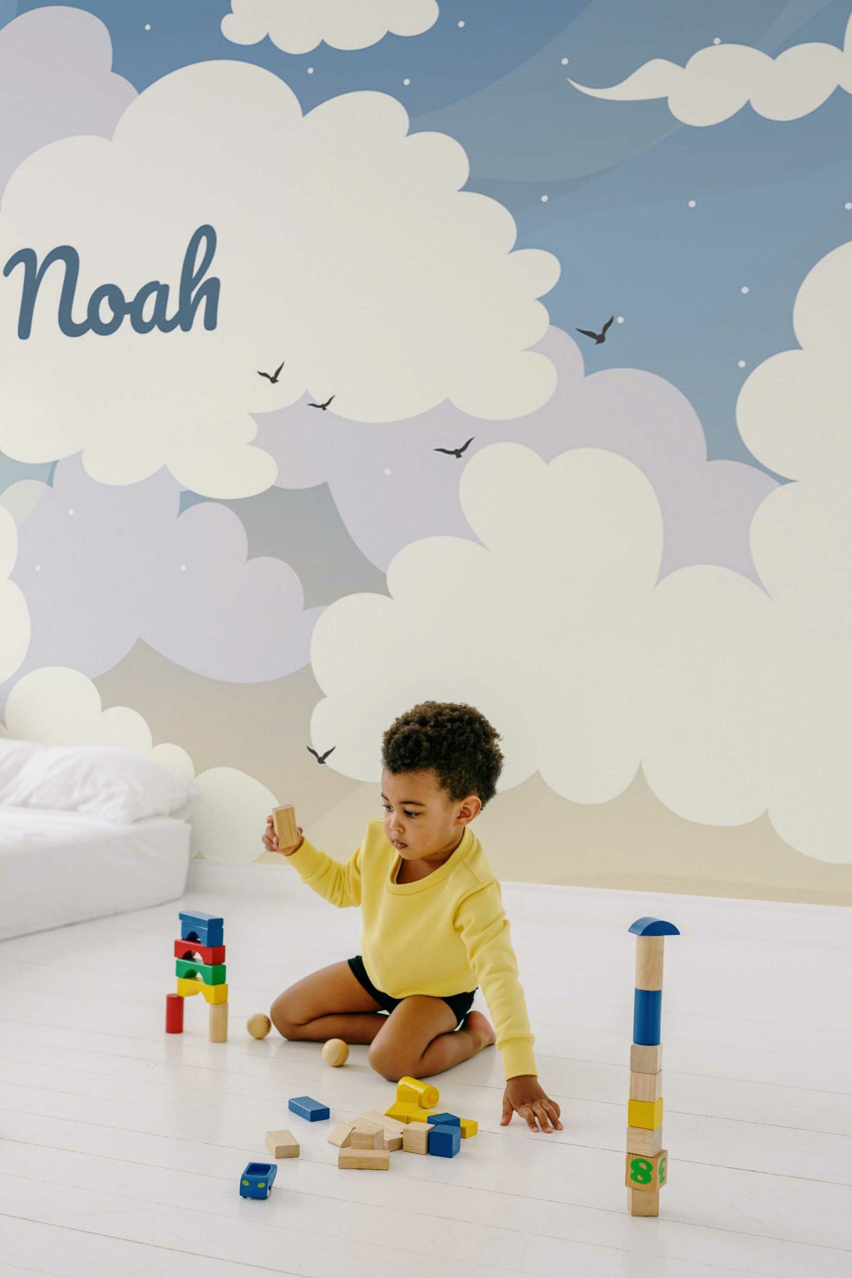 Self-adhesive wall mural in Blue Sky Baby's Name Cloudy design by Fancy Walls