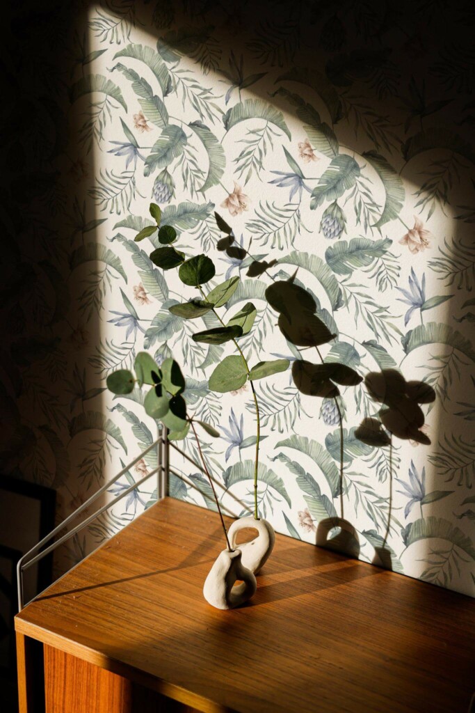 Mid-century style living room decorated with Green and white tropical leaf peel and stick wallpaper