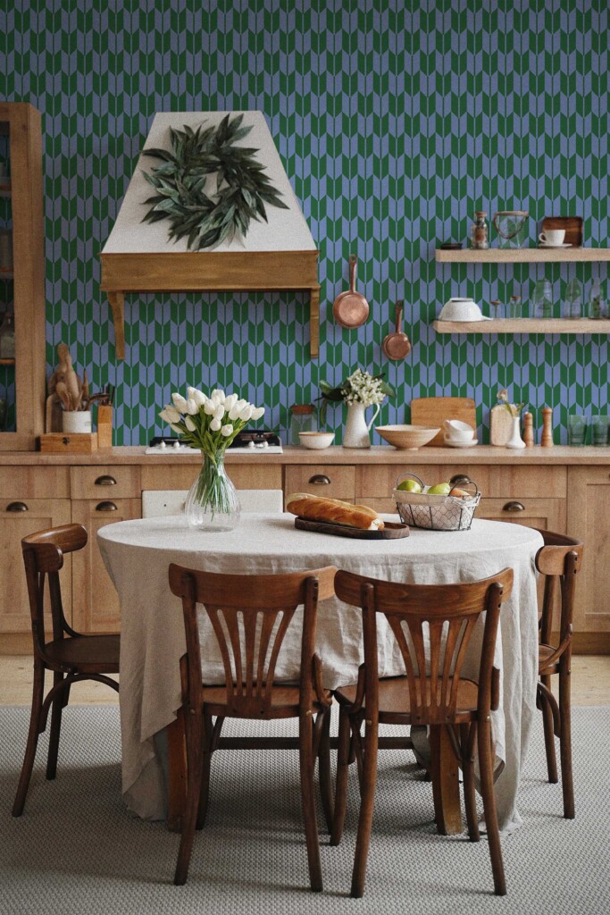 A modern kitchen with wooden furniture and Herringbone Flow wallpaper in green and blue geometric chevron pattern, creating a stylish retro backdrop. The design adds depth and rhythm to the space, perfect for eclectic or mid-century-inspired interiors. Fancy Walls peel and stick or non-pasted wallpaper made from eco-friendly materials.
