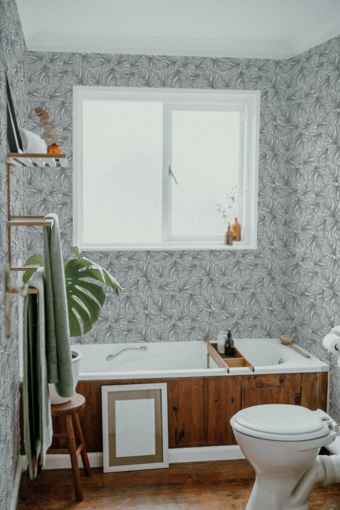 Boho farmhouse style bathroom decorated with Monstera leaf peel and stick wallpaper