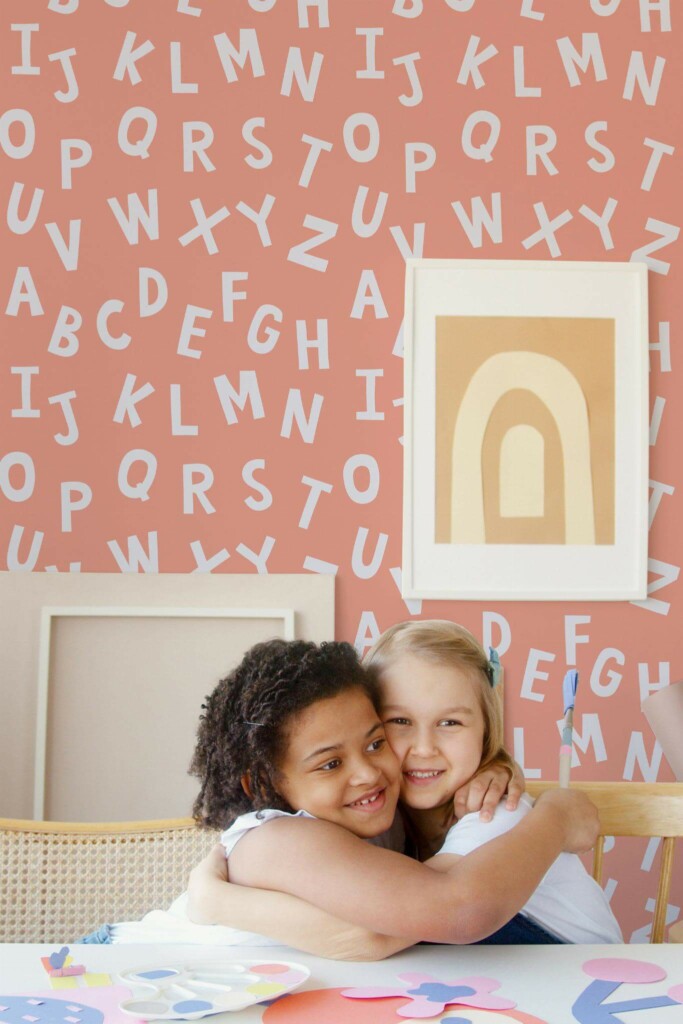 Boho style kids playroom decorated with Pink alphabet peel and stick wallpaper
