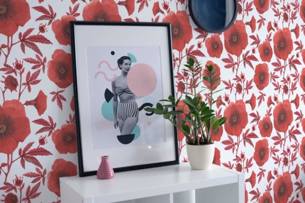 Red poppy stick on wallpaper