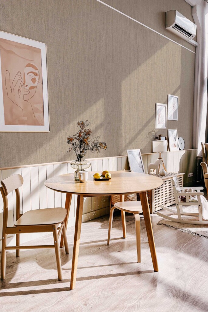 Scandinavian-style dining nook with light wood furniture and minimalist decor, enhanced by the soft woven texture of the Fog Retro Talbott Grasscloth wallpaper in taupe-beige. The design brings a sense of warmth and quiet sophistication. Fancy Walls removable peel and stick or non-pasted wallpaper.