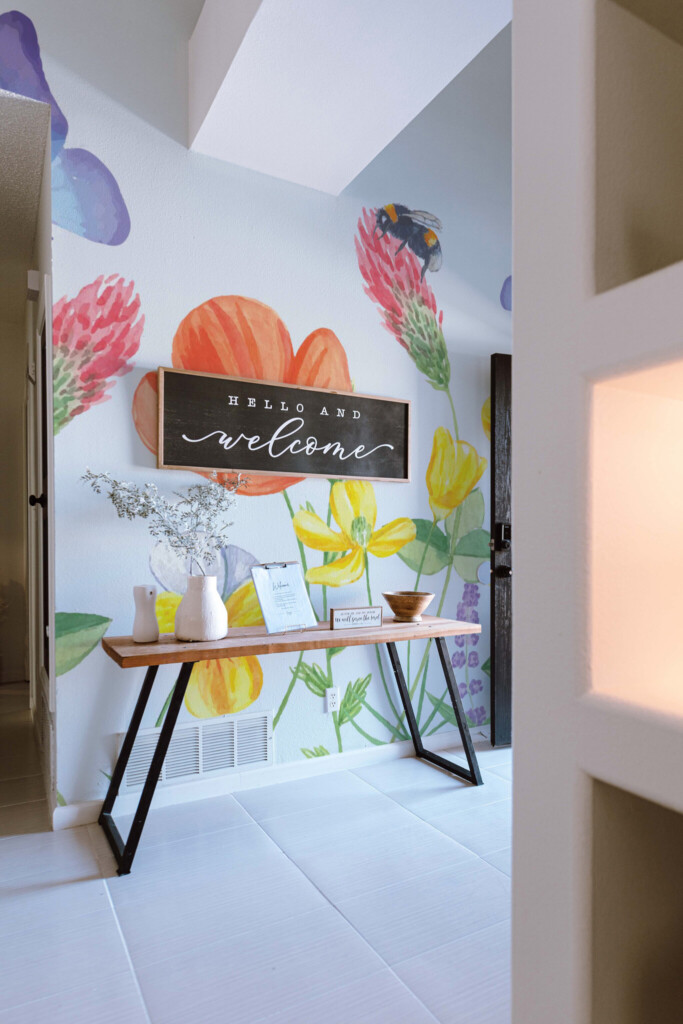 Wall paper mural with hand-painted floral meadow scene including bees and butterflies in colorful palette by Fancy Walls