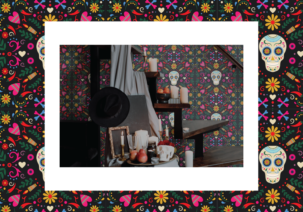 Statement wall with colorful Sugar Skull design in a dimly lit room.