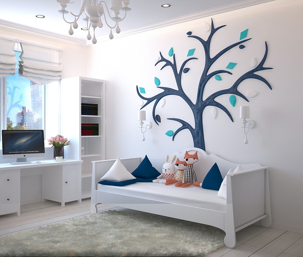 A children’s bedroom with a wall art design of a tree