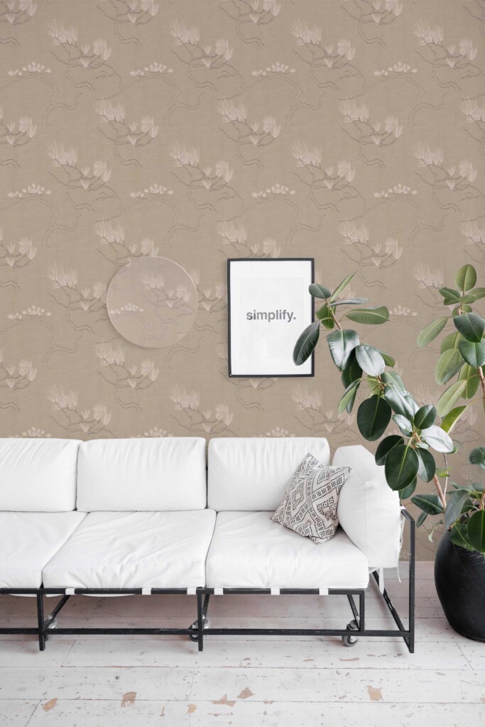 Modern living room with a white sofa, abstract artwork, and potted greenery, featuring the Tan Branching Bonsai wallpaper with soft tree branches and blossoms. The botanical pattern brings calm and organic flow to the space. Fancy Walls removable peel and stick or non-pasted wallpaper.