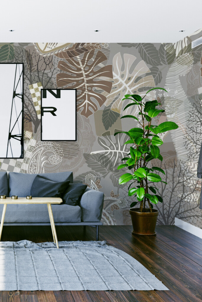 Wall paper mural in a tropical paisley style featuring overlapping monstera leaves, bare trees, and delicate floral doodles in muted earthy colors. The Fancy Walls peel and stick or non-pasted wallpaper.