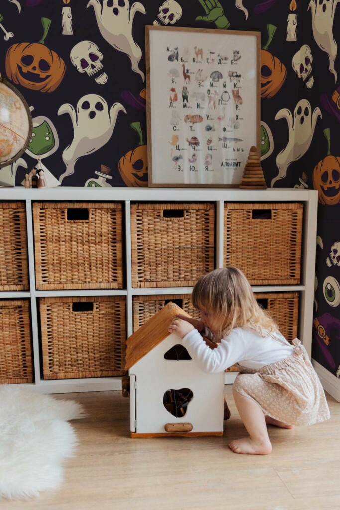 Boho gender neutral style kids room decorated with Vibrant Halloween Haunt peel and stick wallpaper