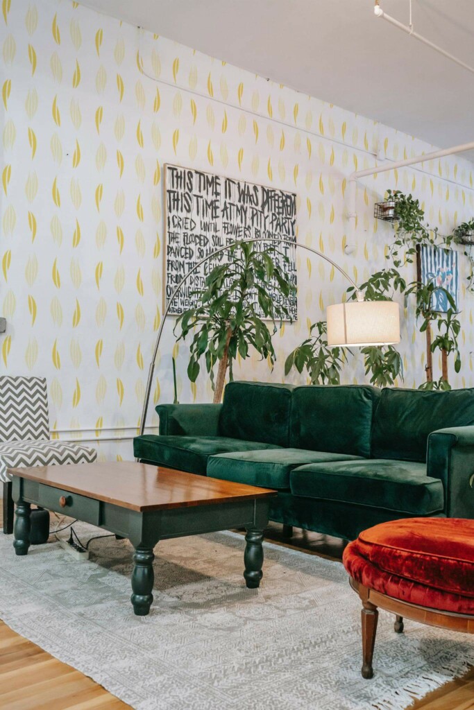 Bold eclectic style living room decorated with Yellow abstract leaf peel and stick wallpaper and emerald green sofa